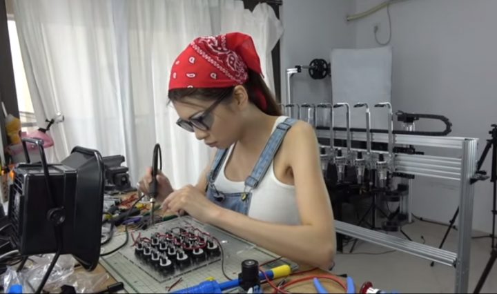 picture of Naomi Wu at a work bench soldering electronics