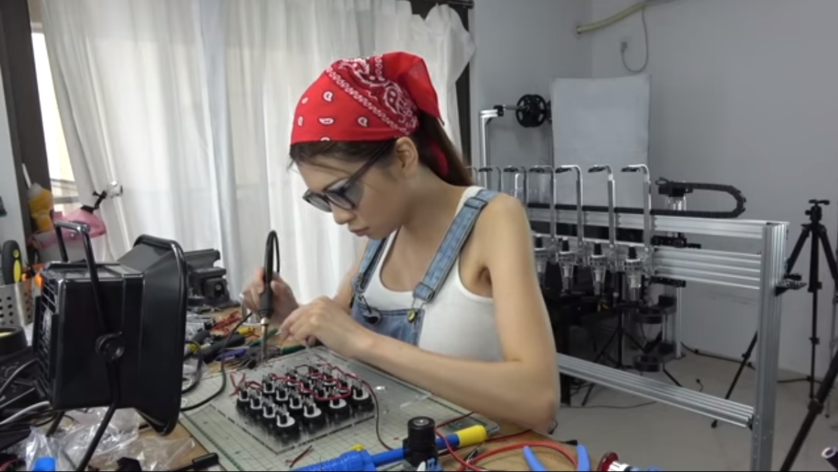 picture of Naomi Wu at a work bench soldering electronics