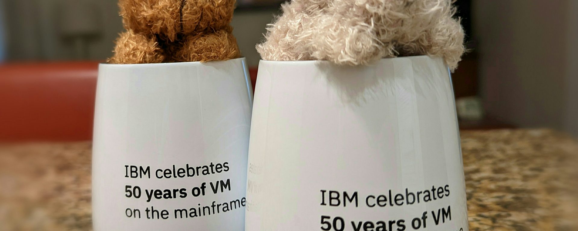 small soft teddy bears in cups with VM 50th Anniversary workshop printed on them